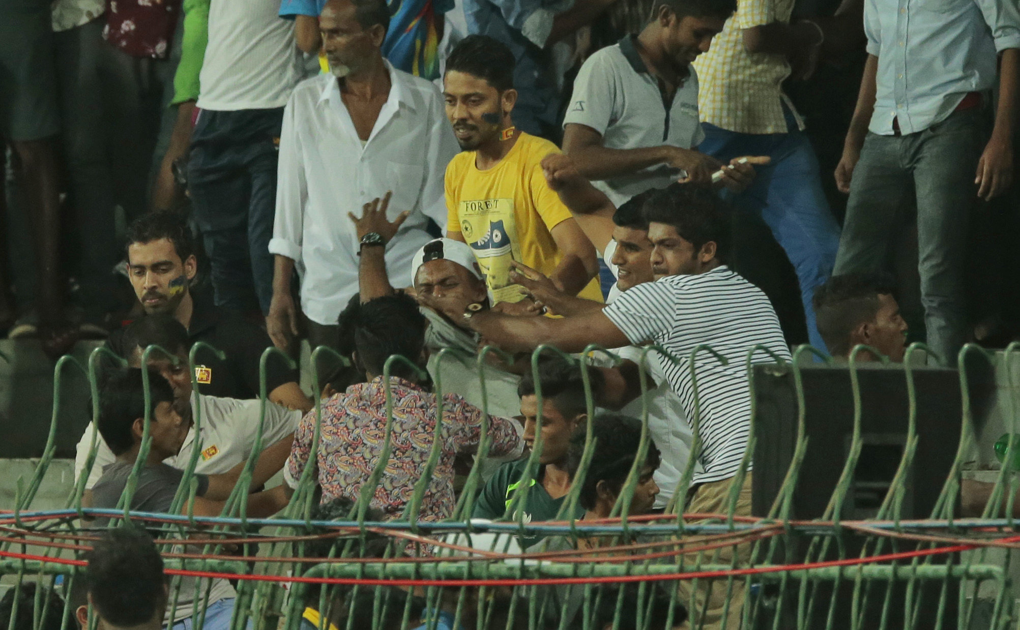 Rioting crowds forced cricketers to retreat to their dressing rooms as projectiles reached the outer field of the Premadasa Stadium during the third one-day international between Pakistan and hosts Sri Lanka on Sunday. (Photo: AP) Rioting crowds forced cricketers to retreat to their dressing rooms as projectiles reached the outer field of the Premadasa Stadium during the third one-day international between Pakistan and hosts Sri Lanka on Sunday. (Photo: AP)